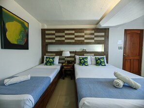 Deluxe Quadruple Room | Desk, iron/ironing board, bed sheets - The Palacio de Laoag (Laoag)