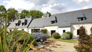 A courtyard with outdoor seating and a garden.