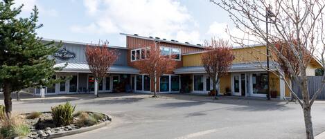 A commercial building with a storefront named "The Salon" and a parking lot in front.