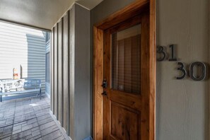A wooden door with the numbers 31 and 30 on the wall beside it.