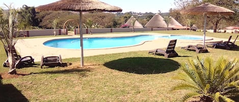 Outdoor pool, open 6:00 AM to 6:00 PM, pool umbrellas