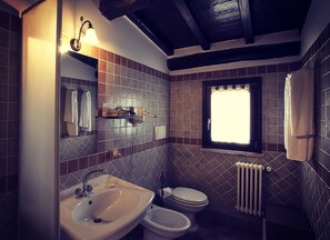 A bathroom with a sink, toilet, and window. - Relais Il Casale (Rome)