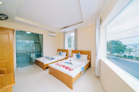 Deluxe Triple Room, 1 Bedroom, Sea View | Minibar, desk, blackout drapes, soundproofing