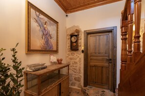 A wooden staircase with a wooden door and a wall-mounted clock. - Saye Konak Kaleiçi&Oldtown (Antalya)