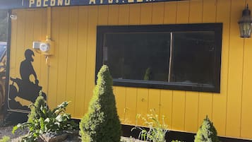 A yellow building with a sign reading "POCONDO ATV.COM".