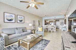 A living room with a sofa, coffee table, and artwork on the wall. - ⛱️ Walk to Beach~19th floor Gulf Views~2 Pools~The Radiant Vista☀️ (Miramar Beach)