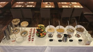 A dining area with tables set for a meal, featuring a variety of food and drink options. - Tatler Jack (Killarney)