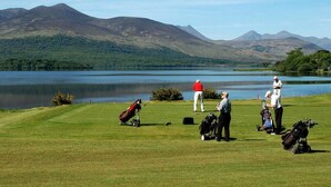 A golf course with a lake and mountains in the background. - Tatler Jack (Killarney)