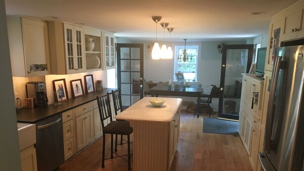 A modern kitchen with wooden cabinets, a central island, and a stainless steel refrigerator. - Great location for college visits/move-in, parents weekend, Merion Golf, Phila! (Ardmore)