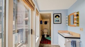 A bathroom with a sink, mirror, and toilet. - The Beach Haus on Copper Mountain Preview listing (Frisco)