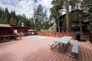 Relax on the deck with a hot tub, picnic table, and barbecue grill.