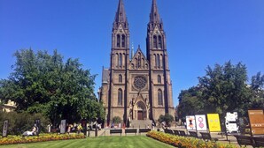 A historic church with twin spires and a large central rose window.
