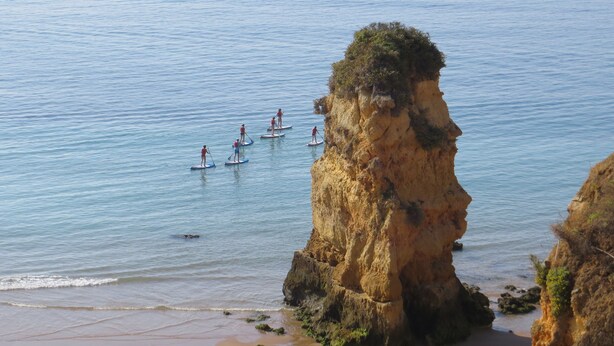 A coastal scene with a rocky cliff and a sandy beach. - Magnificently located apartment with sea view (Lagos)