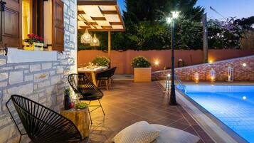 A heated pool, sun loungers
