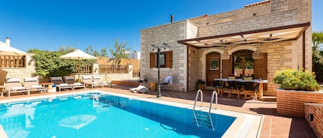 A heated pool, sun loungers