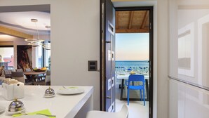 A modern kitchen with a dining area, a view of the sea, and a wooden ceiling. - Villa Argemonia – Luxury Beachfront Escape in Tatinje Bay (Okrug Gornji)