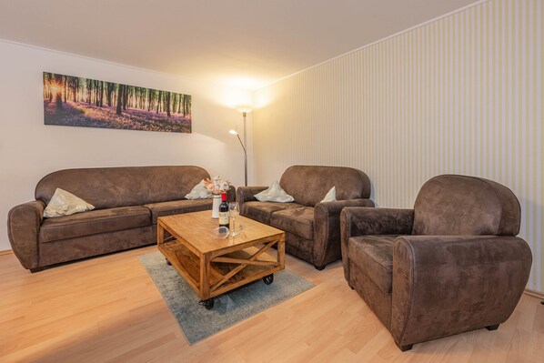 A living room with two sofas, a coffee table, and a floor lamp.