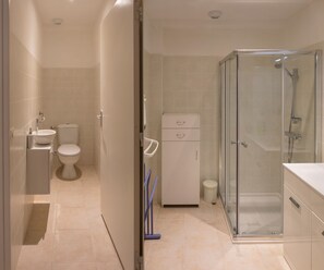 Shower, hair dryer, towels, toilet paper