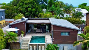 A residential property with a swimming pool, a covered patio, and lush greenery. - Luxury villa 160 m2 with magnificent mountain view and HEATED SWIMMING POOL (Bois d'Olives)