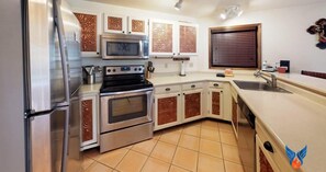 A kitchen with stainless steel appliances, a microwave, and a built-in oven.