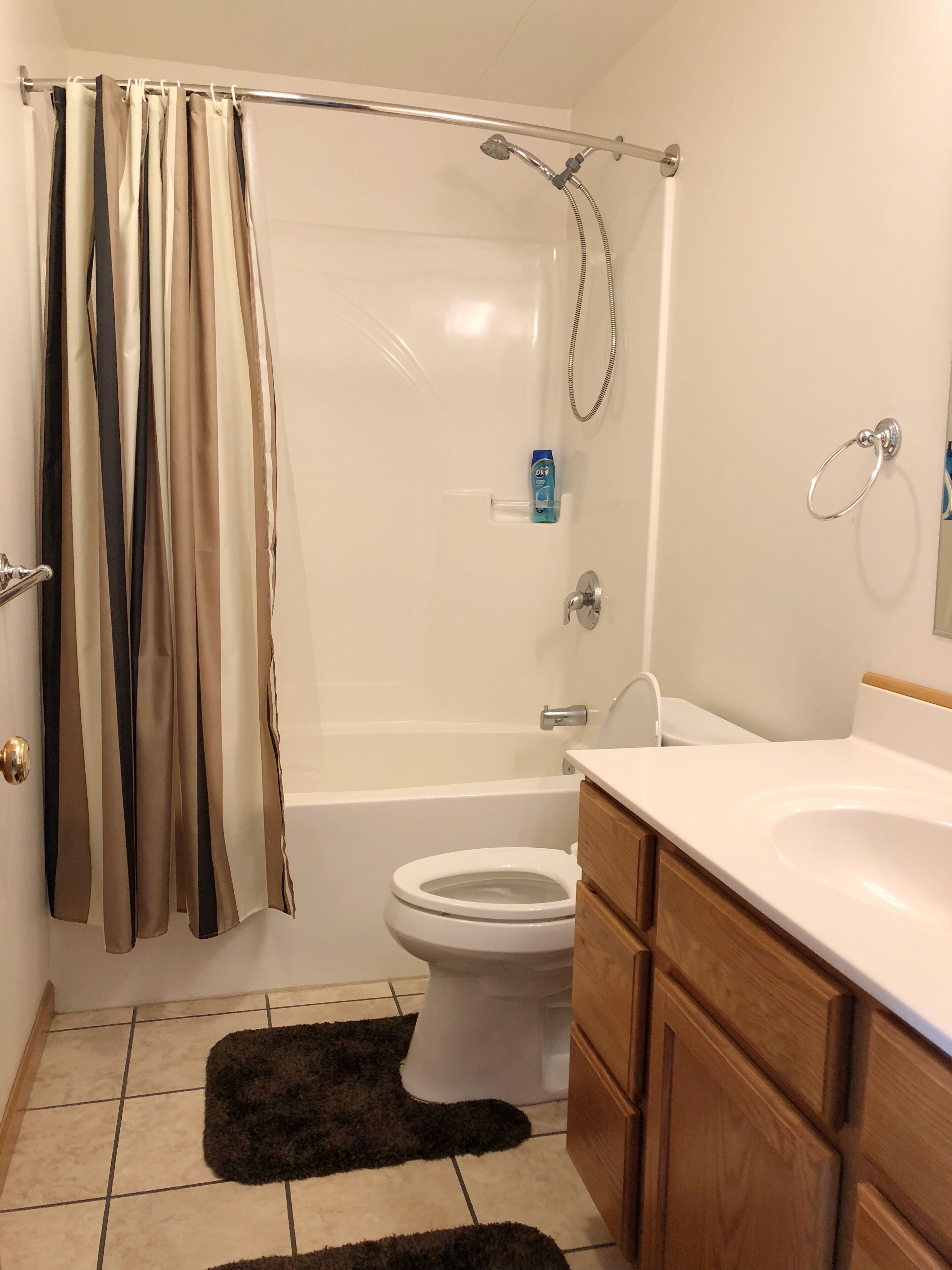 A bathroom with a bathtub, toilet, and sink.