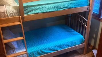 Cozy sleeping quarters feature a bunk bed with a ladder, perfect for a comfortable stay.