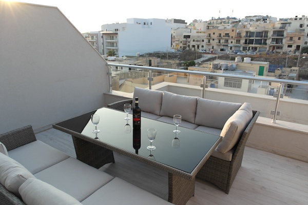 Enjoy a glass of wine and some Maltese snacks as you watch the sun go down