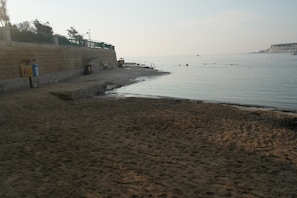 Enjoy a serene beach experience with a clear view of the sandy shore and calm sea.