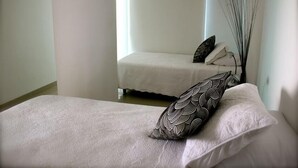 Una stanza con un letto, un comodino e una finestra.