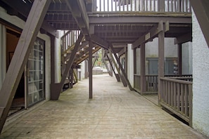 Stairs lead to an upper level from this outdoor deck area.