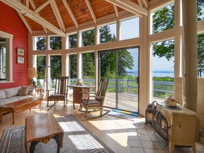 Enjoy a scenic ocean view from the deck, featuring a cozy seating area with a fireplace and comfortable seating.