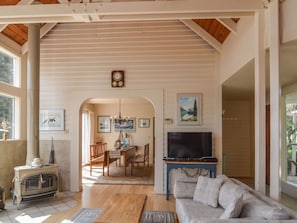 Cozy living area with a fireplace, flat-screen TV, and comfortable sofa.