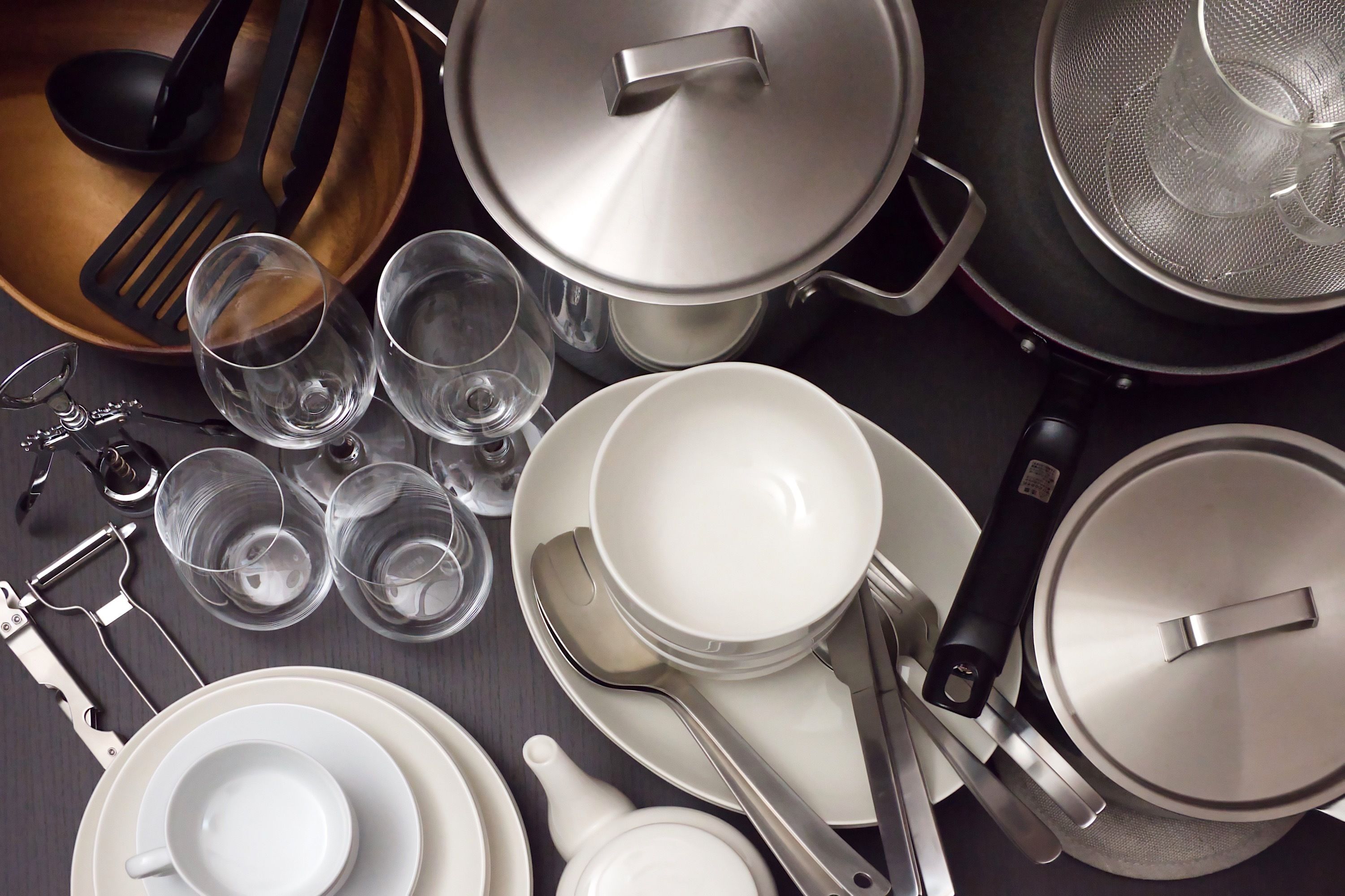 A kitchen with various utensils, pots, and glasses.