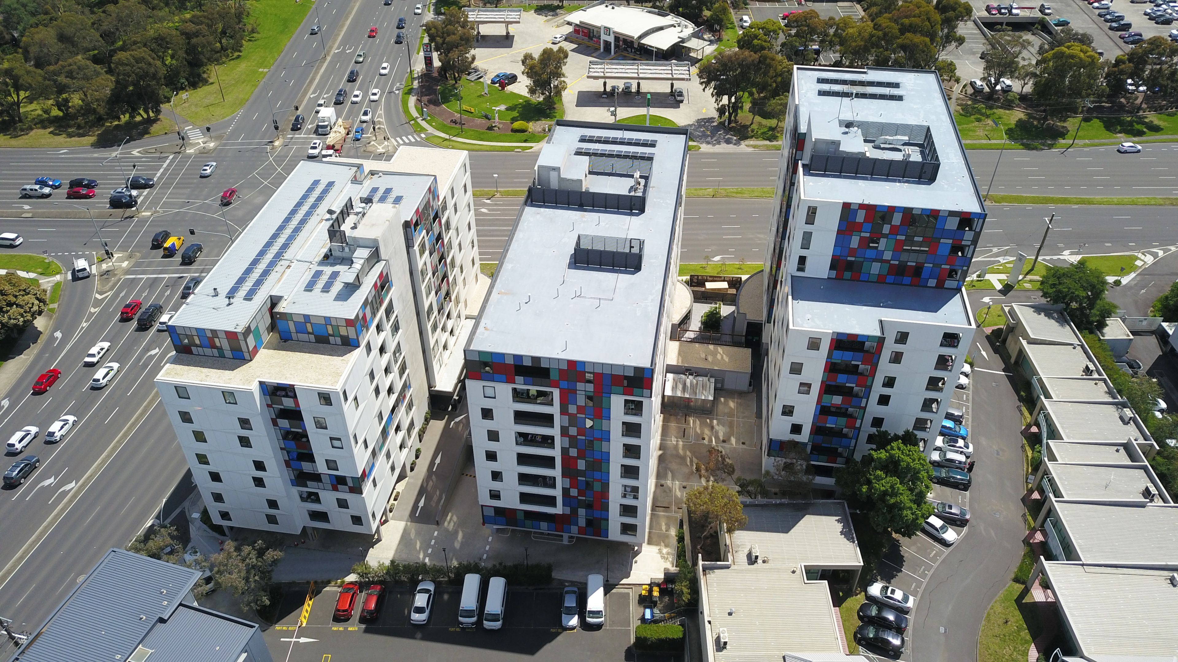 A multi-story building with a modern architectural design, featuring a mix of balconies and large windows.