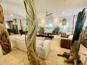 Relax in a spacious living area with a sofa set and natural wood elements.