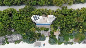 Enjoy beachfront living with a dock and lush tropical surroundings.