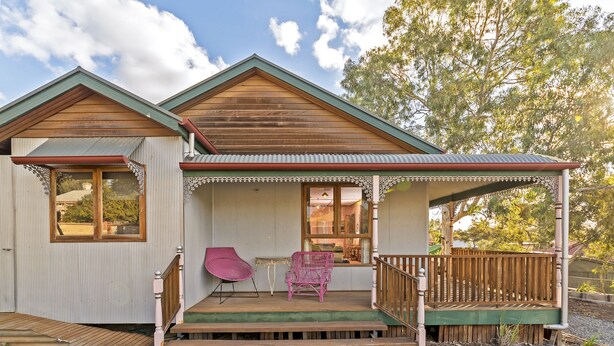 A two-story house with a wooden deck and a covered porch. - A lovely rustic cottage with all the modern conveniences (Gawler South)