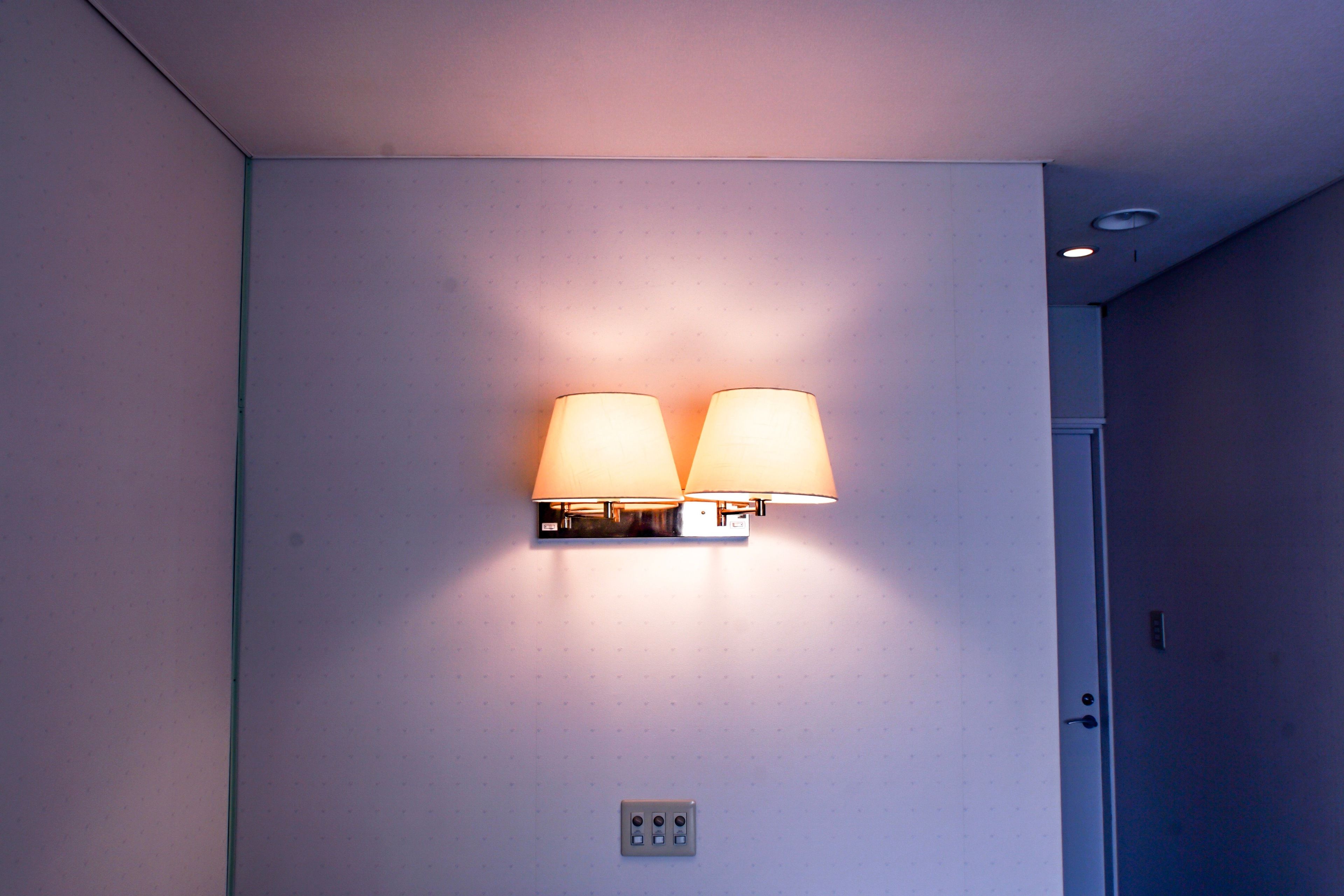 A wall-mounted light fixture with two lamps.