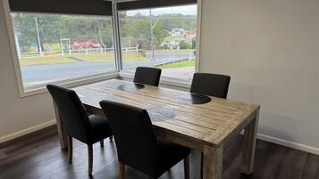 A dining area with a wooden table and four chairs.