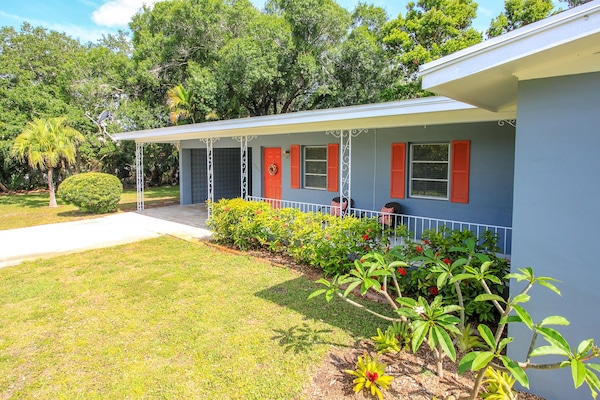 Front porch and carport of home on 2 city lots.