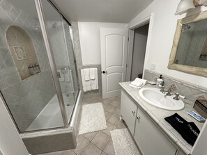 Bathtub, hair dryer, towels, soap