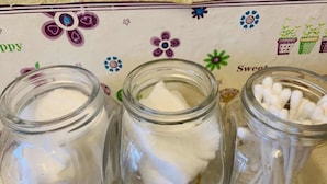 Three glass jars on a table with a floral tablecloth. - Cookoobird Home - Hostel (George Town)