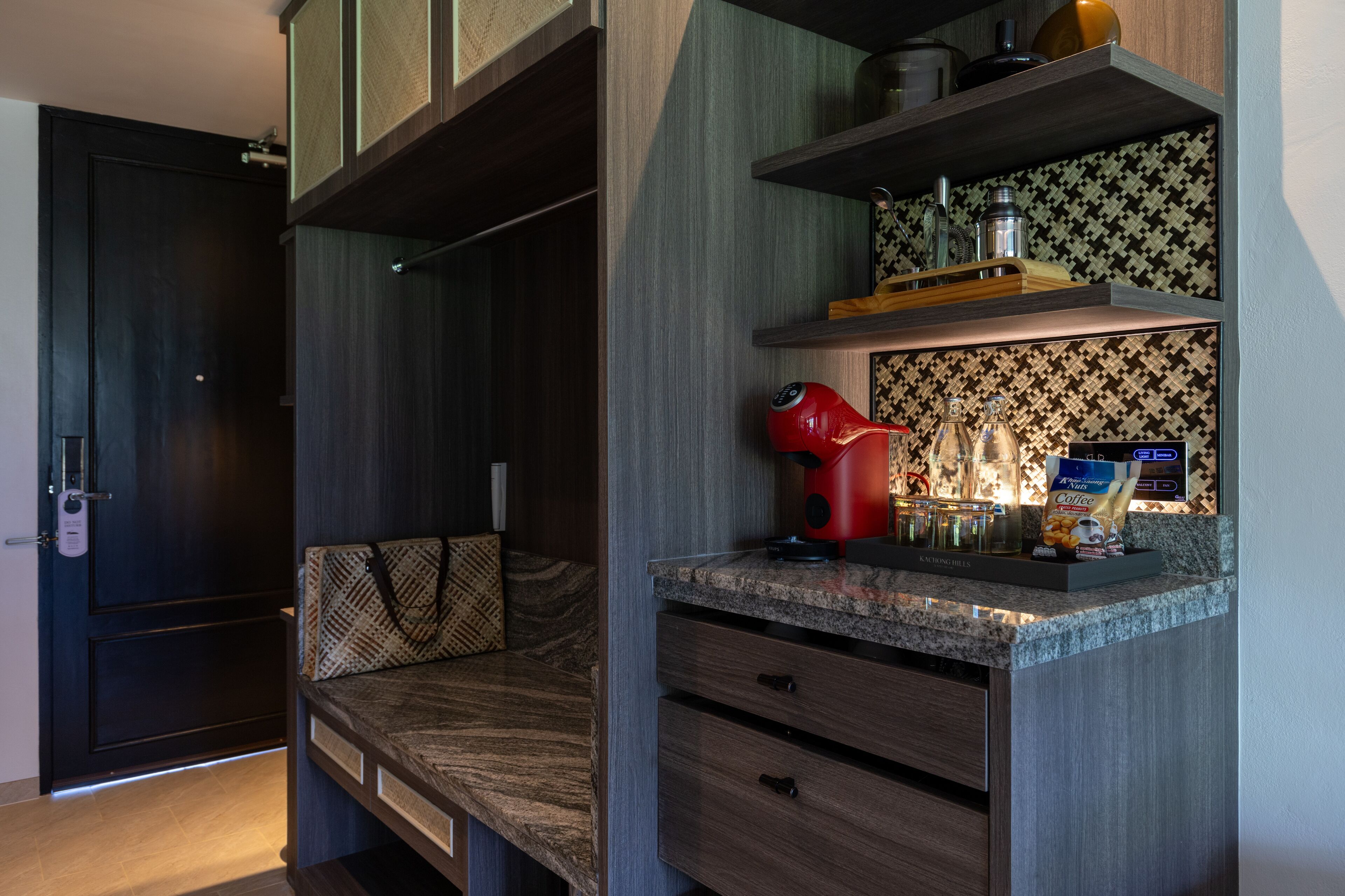 A modern kitchen with a built-in coffee machine, a microwave, and a coffee maker on the countertop.