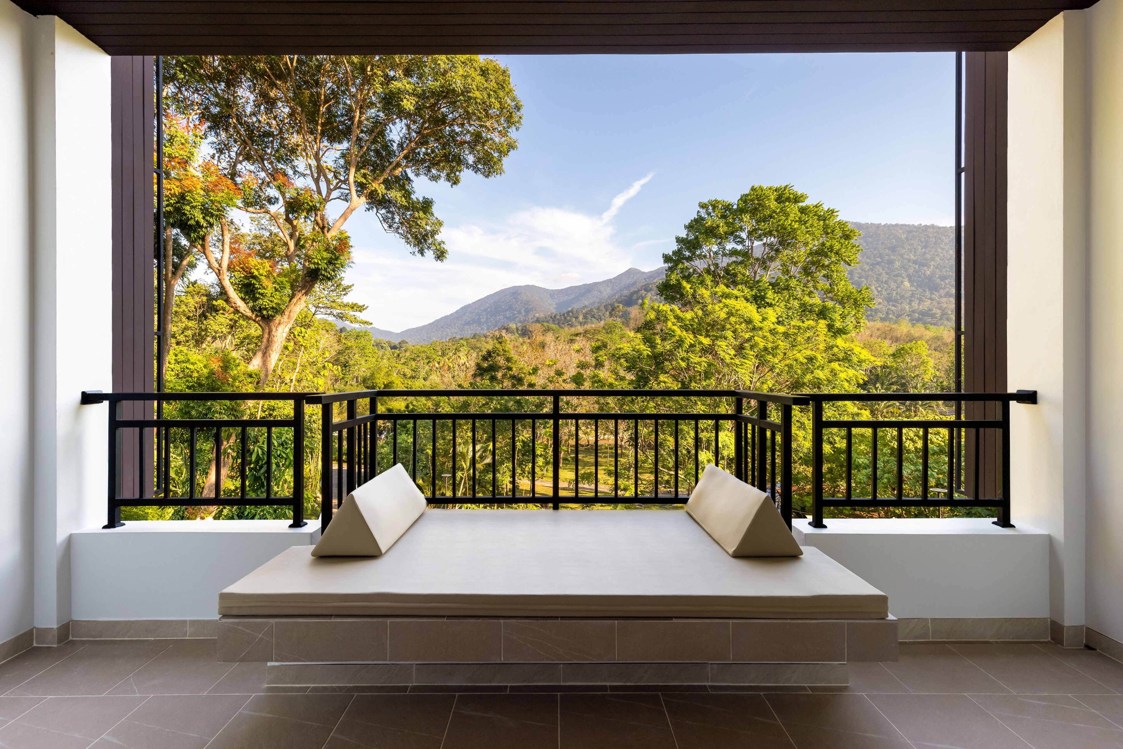 A balcony with a view of a mountainous landscape.