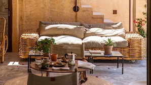 Um quarto acolhedor com uma cama, uma mesa de jantar e uma escada.