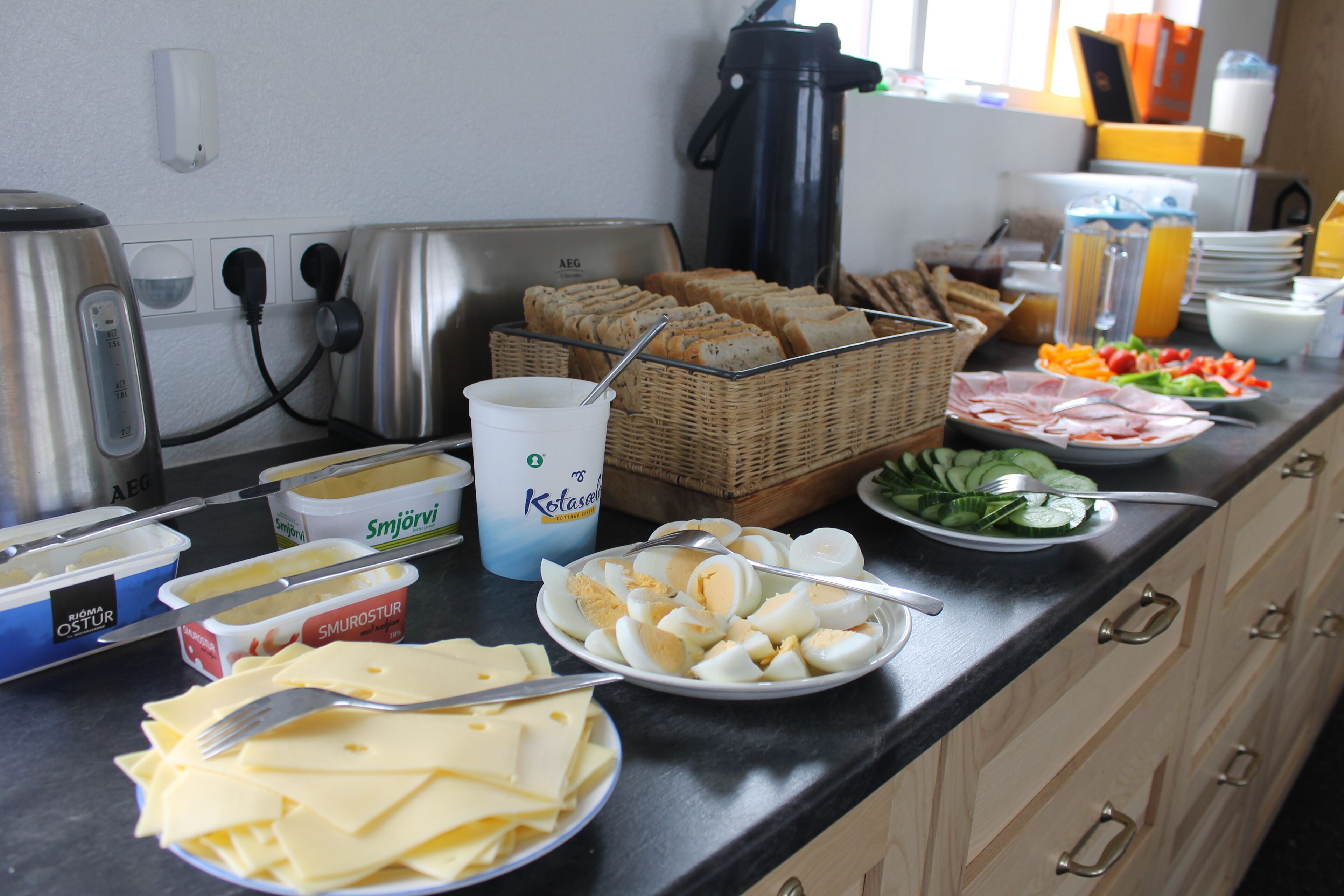 A breakfast buffet with various food items and containers.