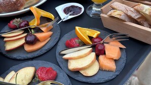 A tray with croissants, fruit, and a glass of orange juice. - B&B Sei Stelle (Sulmona)