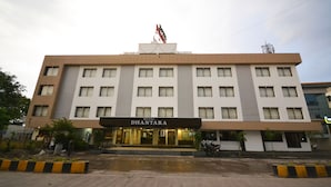 A hotel named "DHANTARA" with a modern facade, multiple windows, and a prominent entrance. - Hotel Dhantara (Rahata)