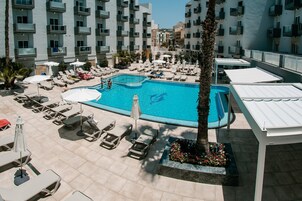 Indoor pool, outdoor pool, open 7:00 AM to 7:00 PM, pool umbrellas