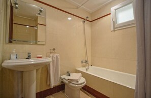 A bathroom with a sink, toilet, and bathtub.